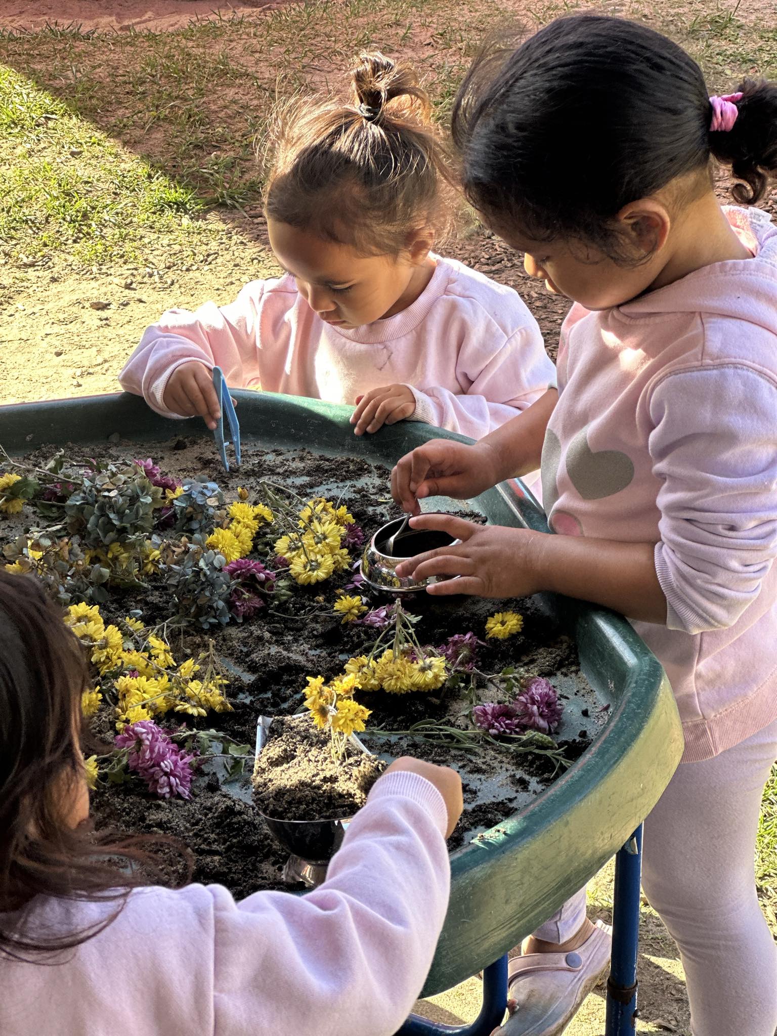 Children creating with flowers and natural materials