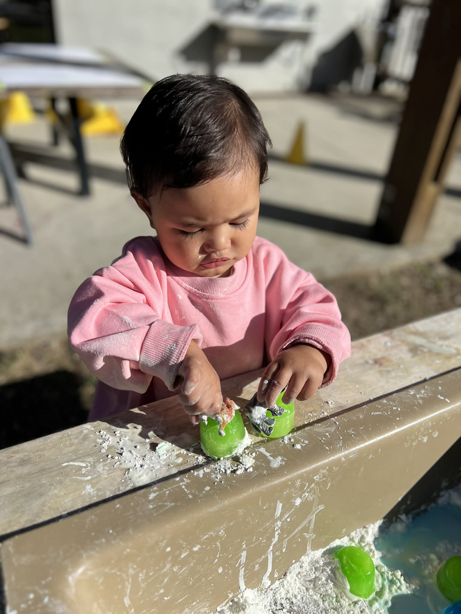 A child deeply engaged in a hands-on sensory activity