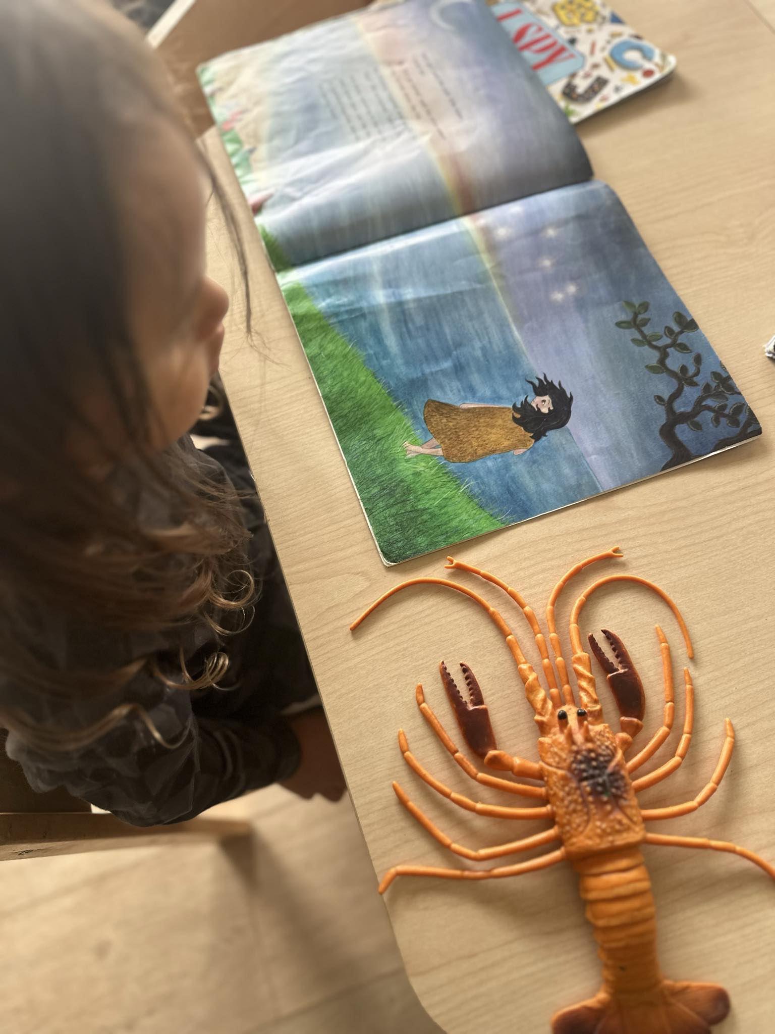 A child using story props during a learning experience