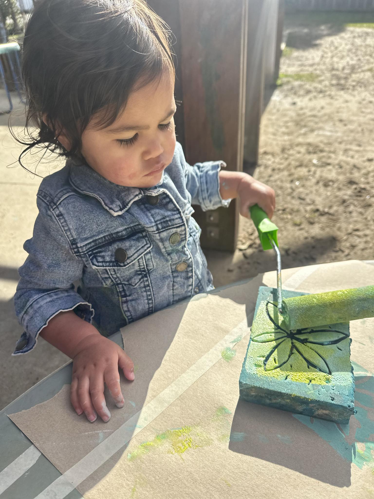 A young child experimenting with water play